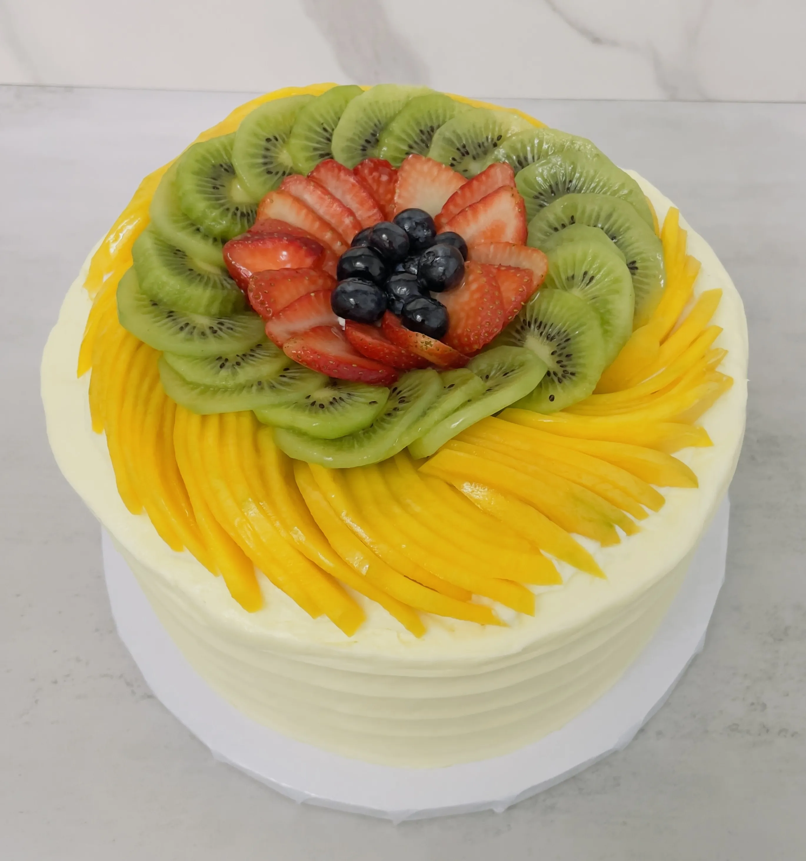 Spring Fling Crown Cake by Chattal Bakery, a zucchini sponge cake with cream cheese frosting and a crown of fresh fruit